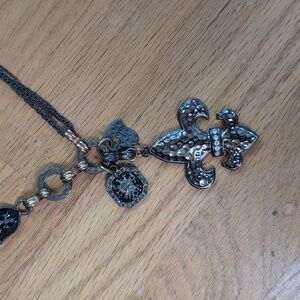 Metal fleur de lis necklace with charms